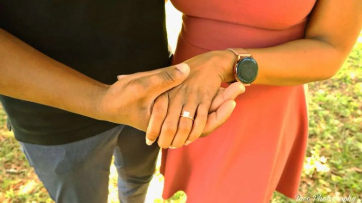 Samuel and Oneisha holding hands, her ring in view