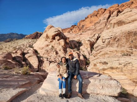 Samuel and Oneisha sitting together on red rock formations