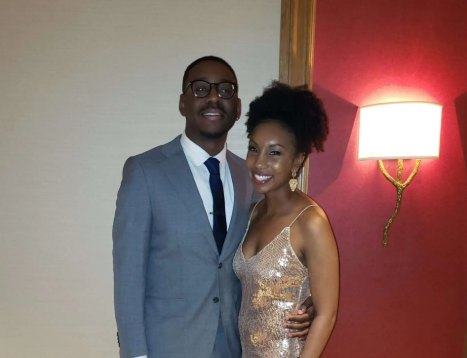 Samuel in a gray suit and Oneisha in a sequined dress